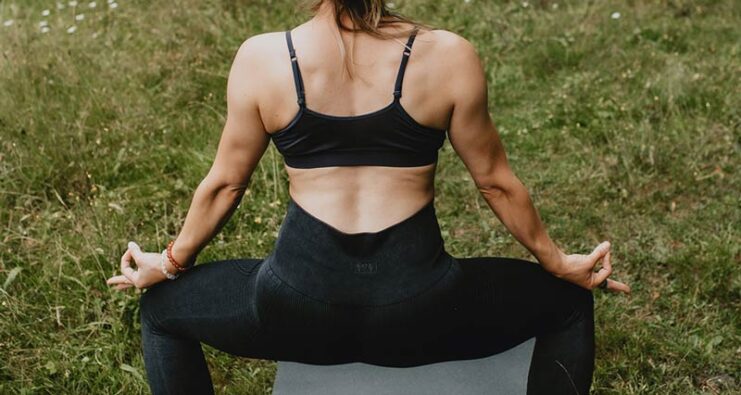 Yogini performing a strong yoga pose