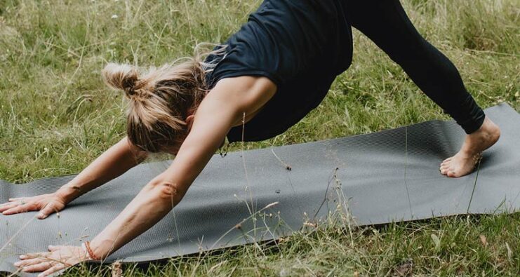 Yogini teaching yoga outdoors in Bury St Edmunds