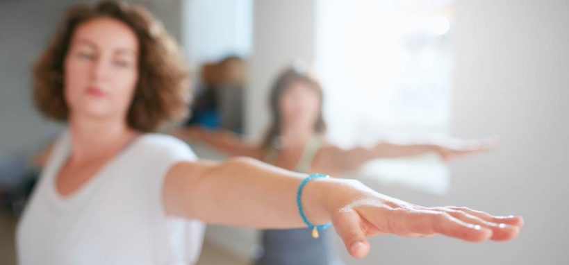 One to one yoga session between two women