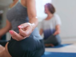 Two women in a lotus yoga meditation pose